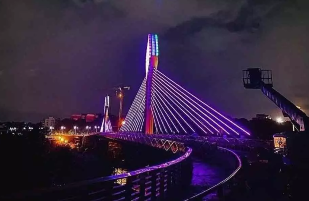 Iconic cable bridge and vibrant Hyderabad city skyline near Madhapur business hub at night – 9 to Thrive office spaces