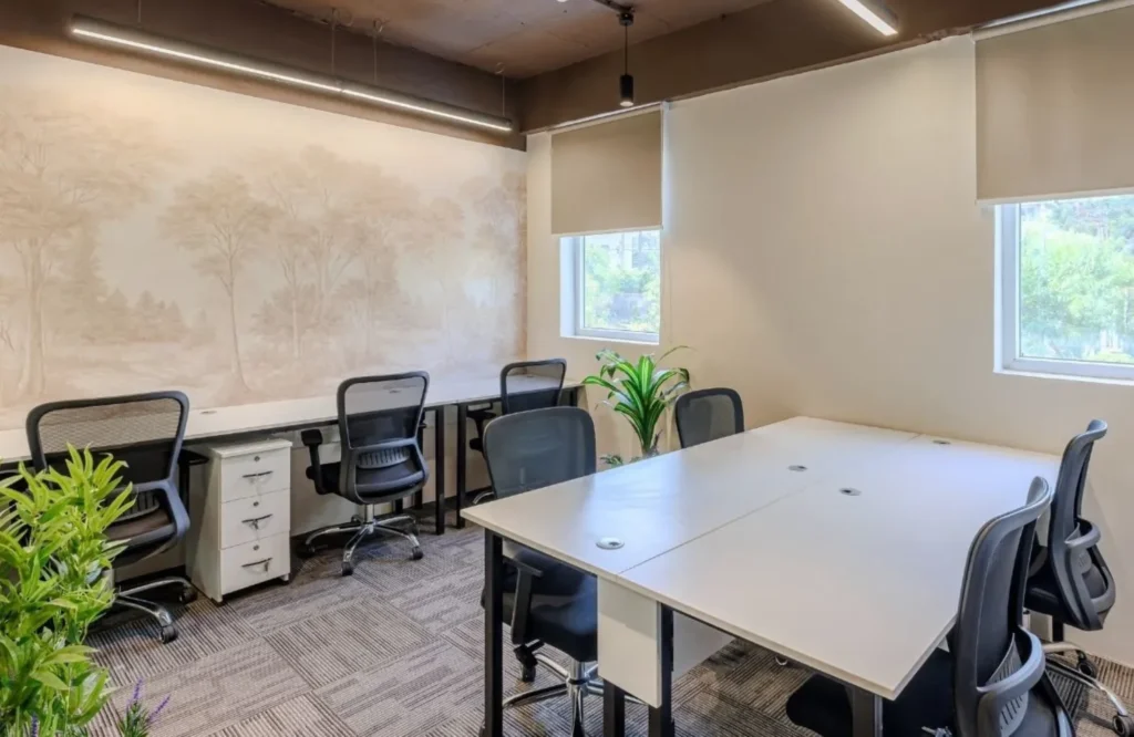 Modern managed office meeting room with collaborative seating, highlighting the difference between managed office space and coworking space for business teams.